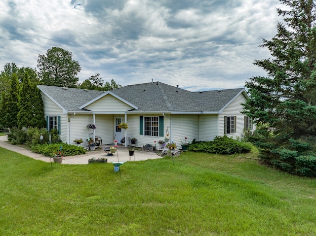 rear view of property featuring a patio area and a yard