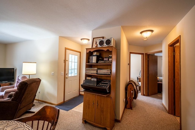 interior space with a textured ceiling and light colored carpet