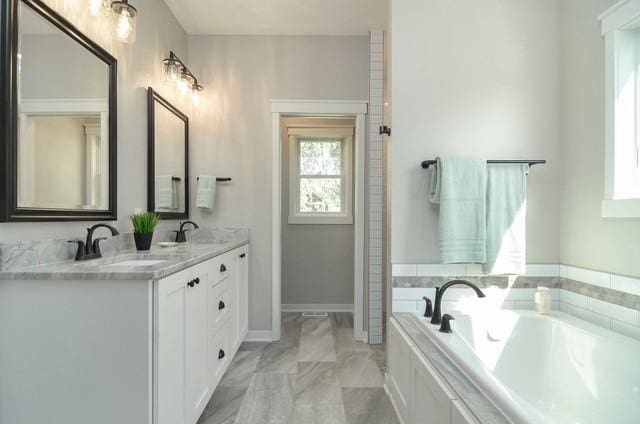 bathroom featuring dual vanity, tile flooring, and a bathing tub