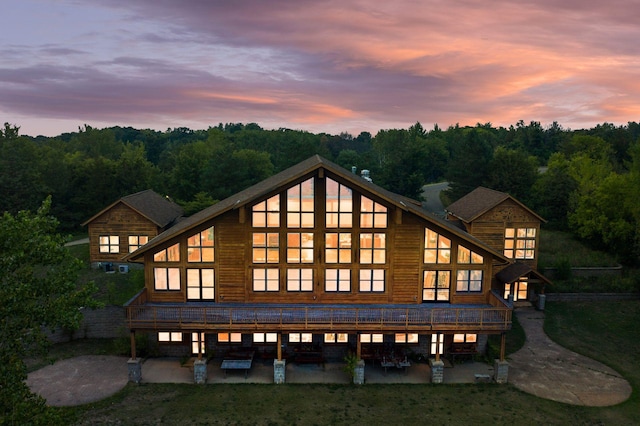 back house at dusk with a patio