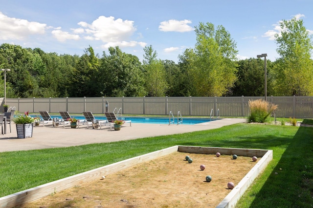 view of swimming pool featuring a patio area and a lawn