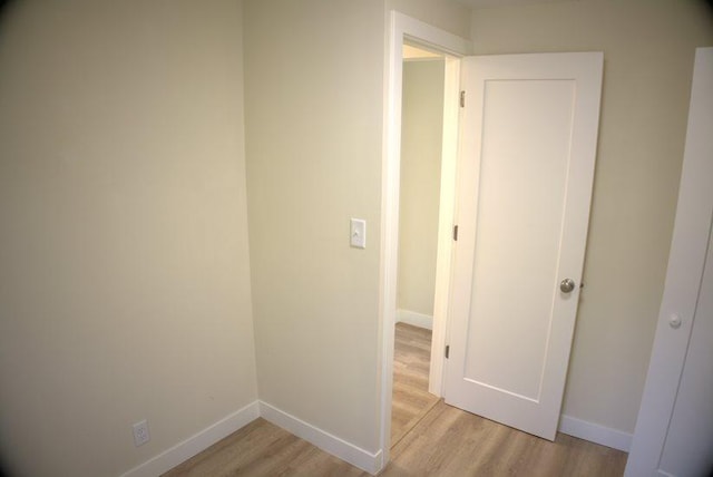 corridor with light hardwood / wood-style flooring