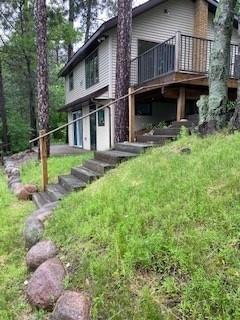 rear view of property featuring a wooden deck