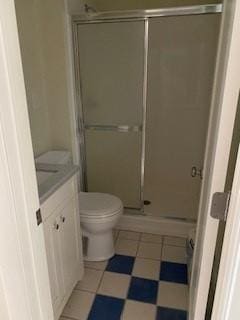 bathroom with vanity, toilet, and a shower with shower door