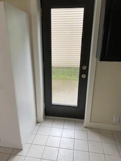 doorway with light tile patterned floors