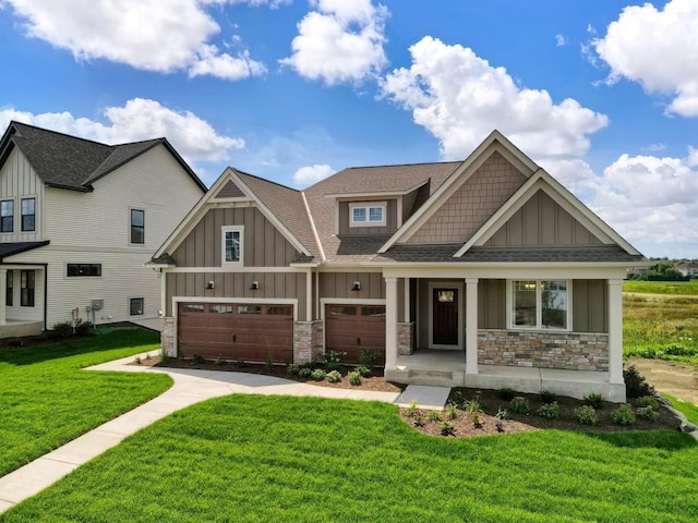 craftsman-style house with a garage and a front lawn