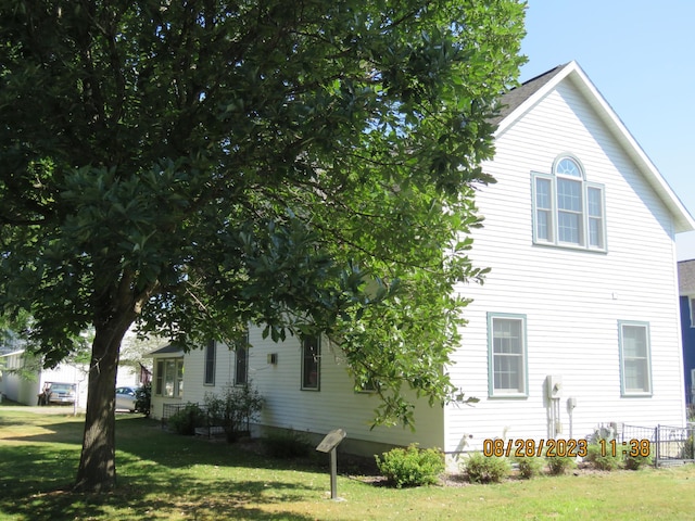 view of property exterior with a yard