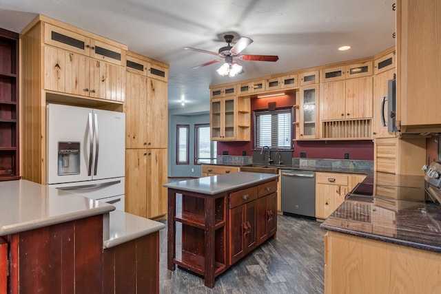 kitchen with a kitchen island, stainless steel appliances, dark hardwood / wood-style floors, sink, and ceiling fan