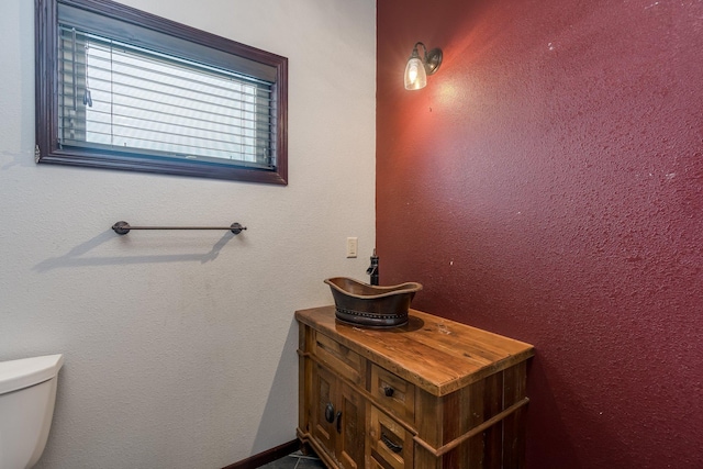 bathroom featuring vanity and toilet