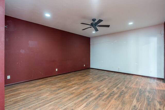 empty room with hardwood / wood-style flooring and ceiling fan