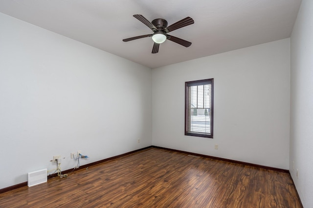 empty room featuring ceiling fan and dark hardwood / wood-style flooring