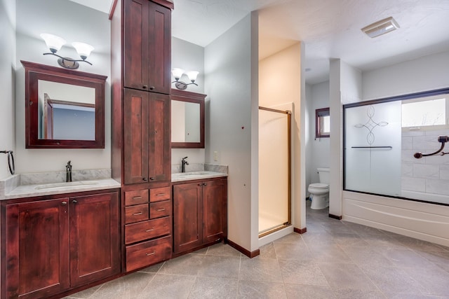 bathroom with double sink vanity, tile flooring, and toilet