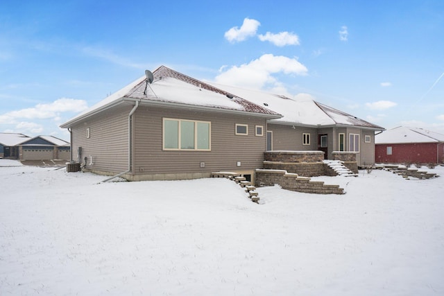 snow covered house with central AC