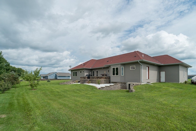 back of property with a patio and a yard