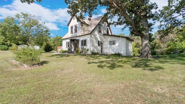 view of property exterior with a lawn