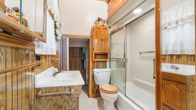 full bathroom with shower / bath combination with glass door, vanity, toilet, and tile patterned floors