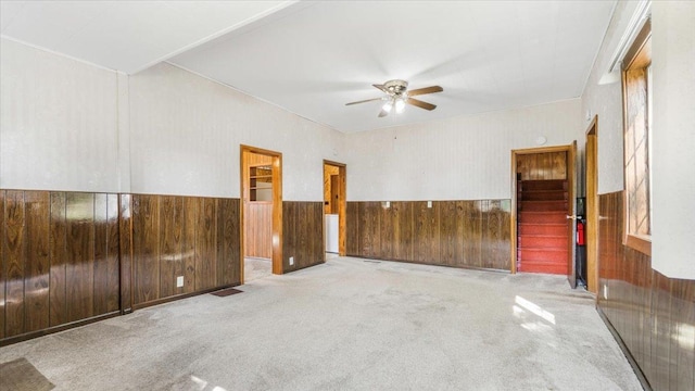 carpeted spare room with ceiling fan