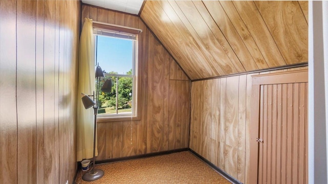 bonus room with lofted ceiling, wooden walls, and carpet