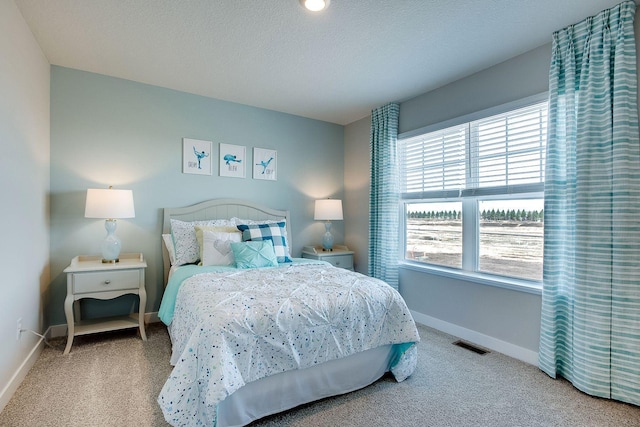 bedroom with carpet flooring and a textured ceiling