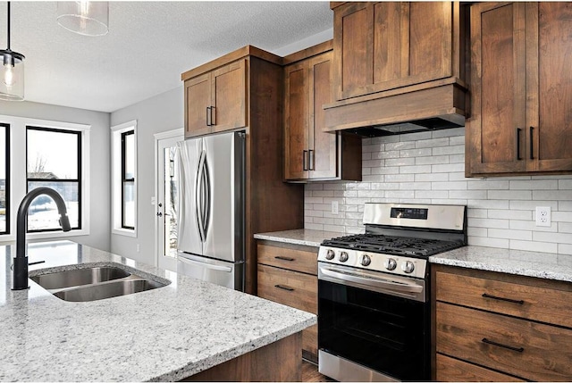 kitchen with stainless steel appliances, premium range hood, decorative light fixtures, and light stone counters