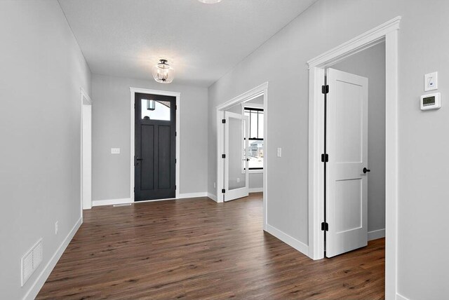 entrance foyer featuring a textured ceiling and dark hardwood / wood-style flooring