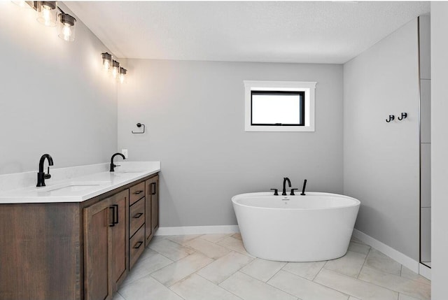 bathroom with a textured ceiling, vanity, and tile flooring