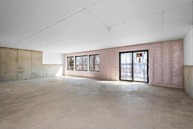 empty room with concrete floors and a healthy amount of sunlight