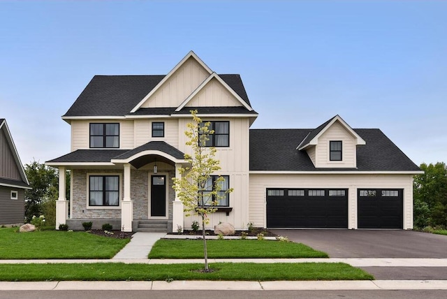 view of front of home with a front yard and a garage