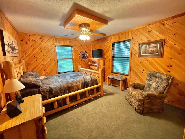 29724 387th St, Waubun, MN 56589 - carpeted bedroom featuring multiple windows, a textured ceiling, wooden walls, and ceiling fan