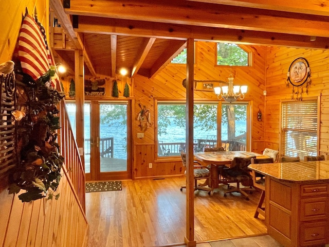 29724 387th St, Waubun, MN 56589 - dining area featuring a chandelier, light wood finished floors, and wooden walls