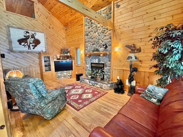 29724 387th St, Waubun, MN 56589 - living area featuring wood finished floors, a fireplace, wooden walls, and lofted ceiling