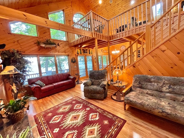 29724 387th St, Waubun, MN 56589 - living area with high vaulted ceiling, stairs, wood walls, healthy amount of natural light, and wooden ceiling