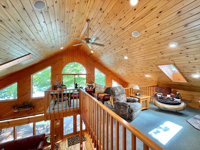 29724 387th St, Waubun, MN 56589 - living room with a skylight, wooden ceiling, lofted ceiling, wooden walls, and a ceiling fan