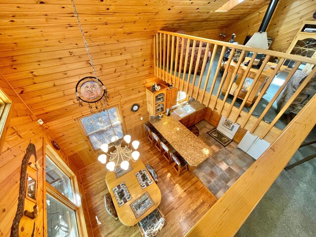29724 387th St, Waubun, MN 56589 - living room featuring wood walls, a chandelier, and a towering ceiling