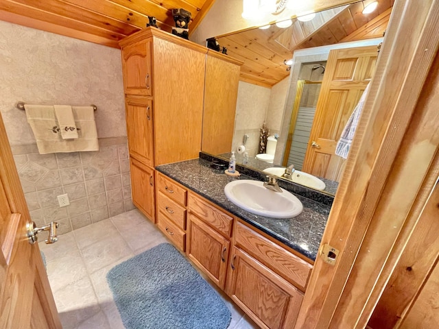 29724 387th St, Waubun, MN 56589 - bathroom with wood ceiling, lofted ceiling, vanity, a stall shower, and tile walls