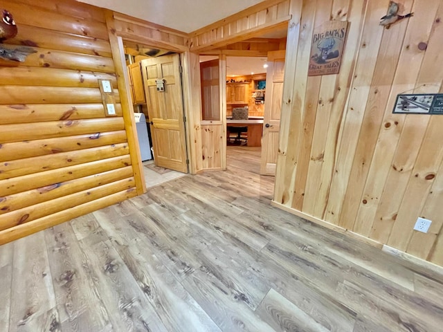 29724 387th St, Waubun, MN 56589 - hallway with light wood-type flooring, rustic walls, and washer / dryer
