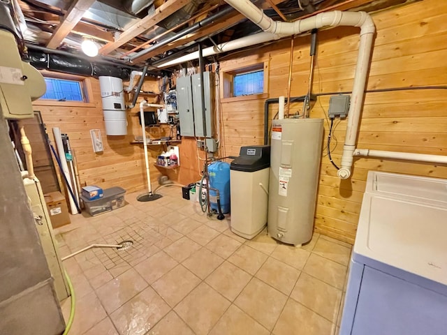 29724 387th St, Waubun, MN 56589 - unfinished basement featuring water heater, wood walls, a central vacuum unit, tile patterned flooring, and washer / clothes dryer