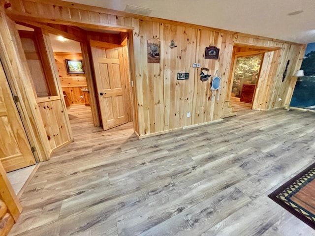 29724 387th St, Waubun, MN 56589 - unfurnished room with wooden walls, light wood-style floors, and baseboards