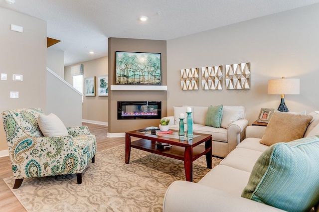 living room featuring hardwood / wood-style floors and a textured ceiling