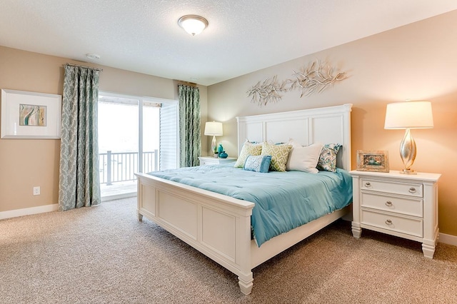 carpeted bedroom featuring a textured ceiling and access to exterior