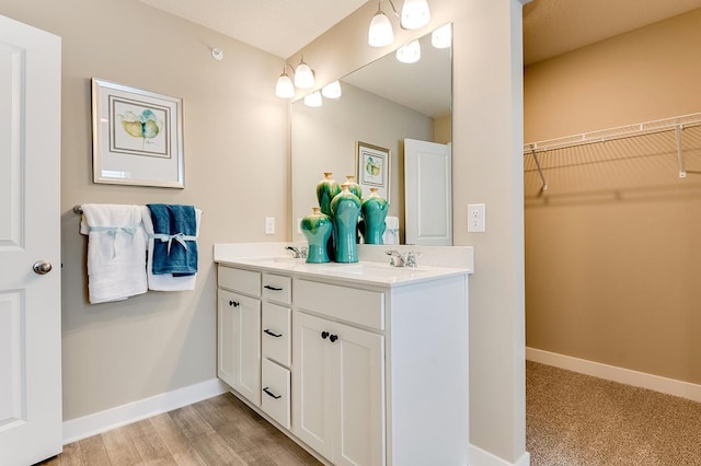 bathroom with hardwood / wood-style floors and vanity