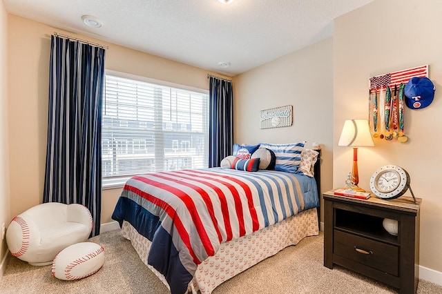 carpeted bedroom featuring a textured ceiling