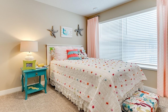 bedroom with carpet and multiple windows