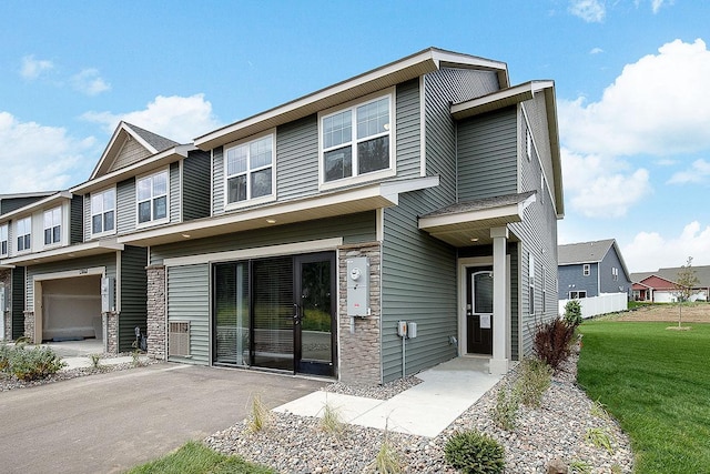 view of front of property featuring a garage and a front lawn