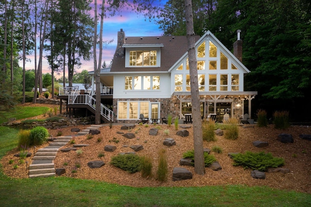 view of back house at dusk