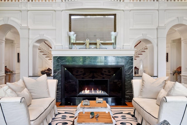 17950 Breezy Point Rd, Woodland, MN 55391 - living room featuring a high end fireplace and arched walkways