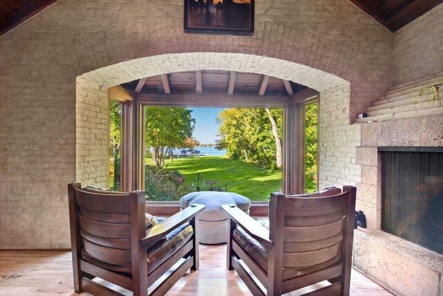 17950 Breezy Point Rd, Woodland, MN 55391 - view of patio / terrace with a fireplace and a water view