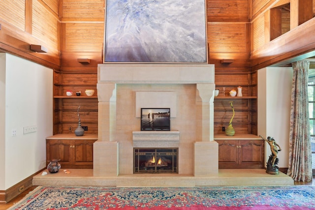 17950 Breezy Point Rd, Woodland, MN 55391 - living area with baseboards, a lit fireplace, and wood walls