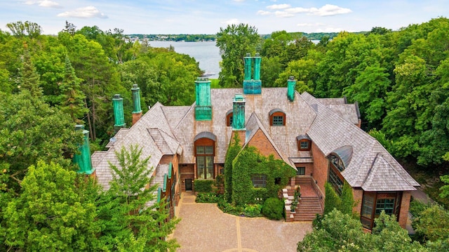 17950 Breezy Point Rd, Woodland, MN 55391 - view of front facade with a chimney, a water view, and stairs