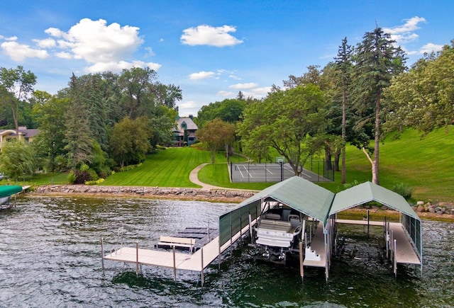 17950 Breezy Point Rd, Woodland, MN 55391 - dock area featuring boat lift, a water view, a yard, and view of scattered trees